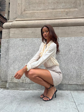 A woman wears shirt with bow tie